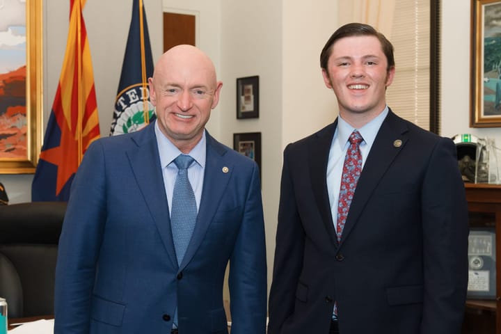 Jackson James and Mark Kelly standing together in an office.